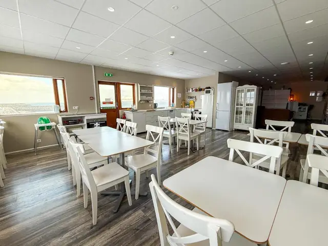 Dining area with sea-facing windows at Við Hafið Oceanfront Guesthouse